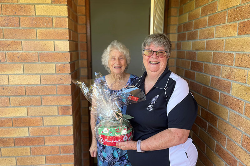 Lin Glass giving Valda Vaughan a Christmas package