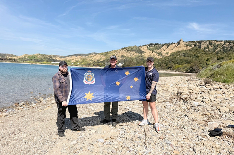 Nathan Shingles and others holding an RSL flag at Gallipoli Peninsula