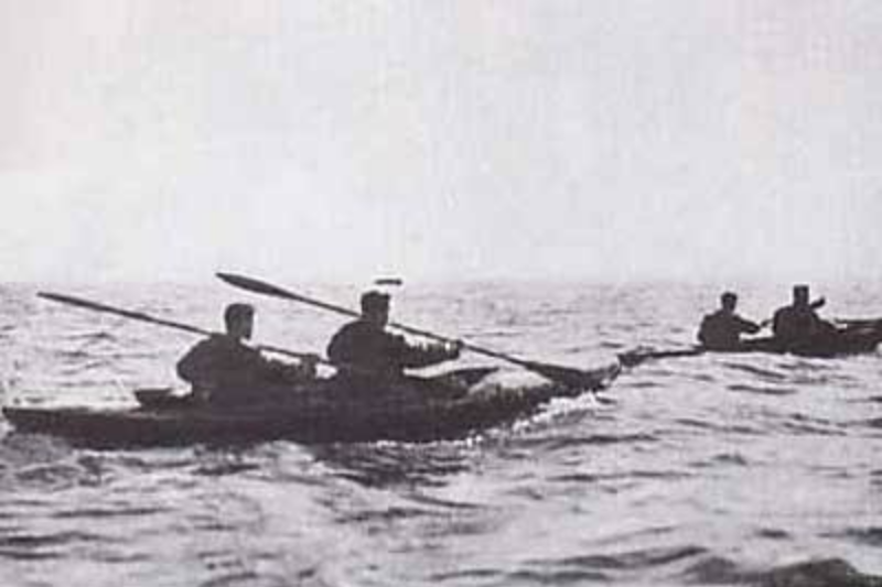 Scorpion Raid canoes on the water in black and white