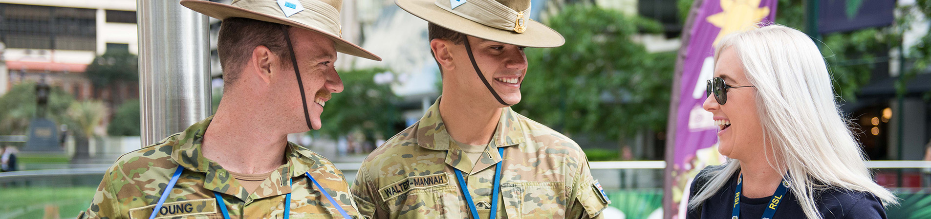 RSL employee laughing with army at poppy appeal
