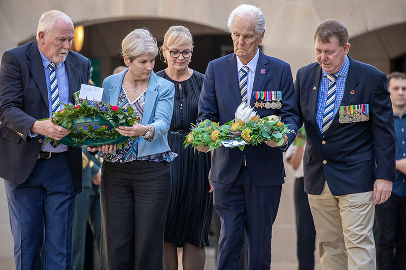 WW2 Veteran, Jim Grebert, holding a wreath