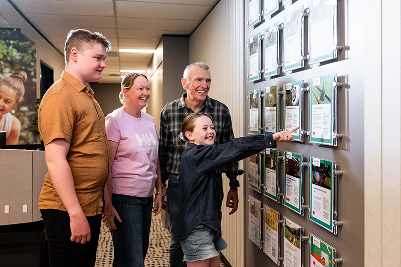 The family look over upcoming activities organised for veterans and their families by the Ipswich Centre.