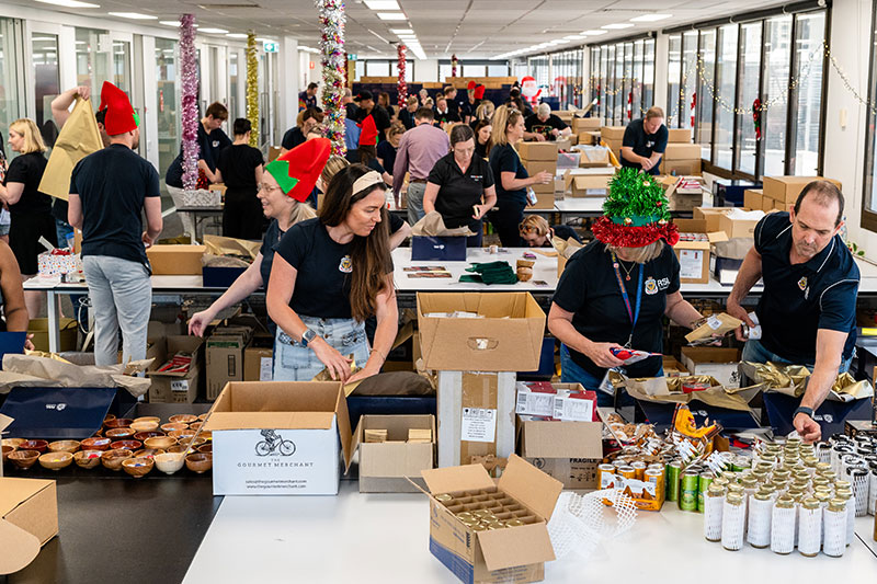 RSL Queensland staff members pack christmas hampers for veterans