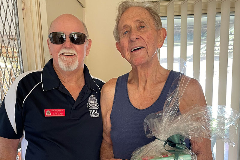 Burleigh RSL Sub Branch Board Member Dave Glass presents Don Anderson with Christmas present