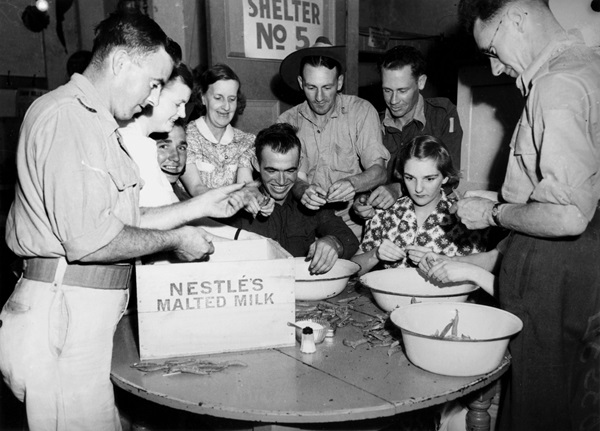 Soldiers on leave help volunteers shell peas at RSL Welfare Rooms at Brisbane City Hall