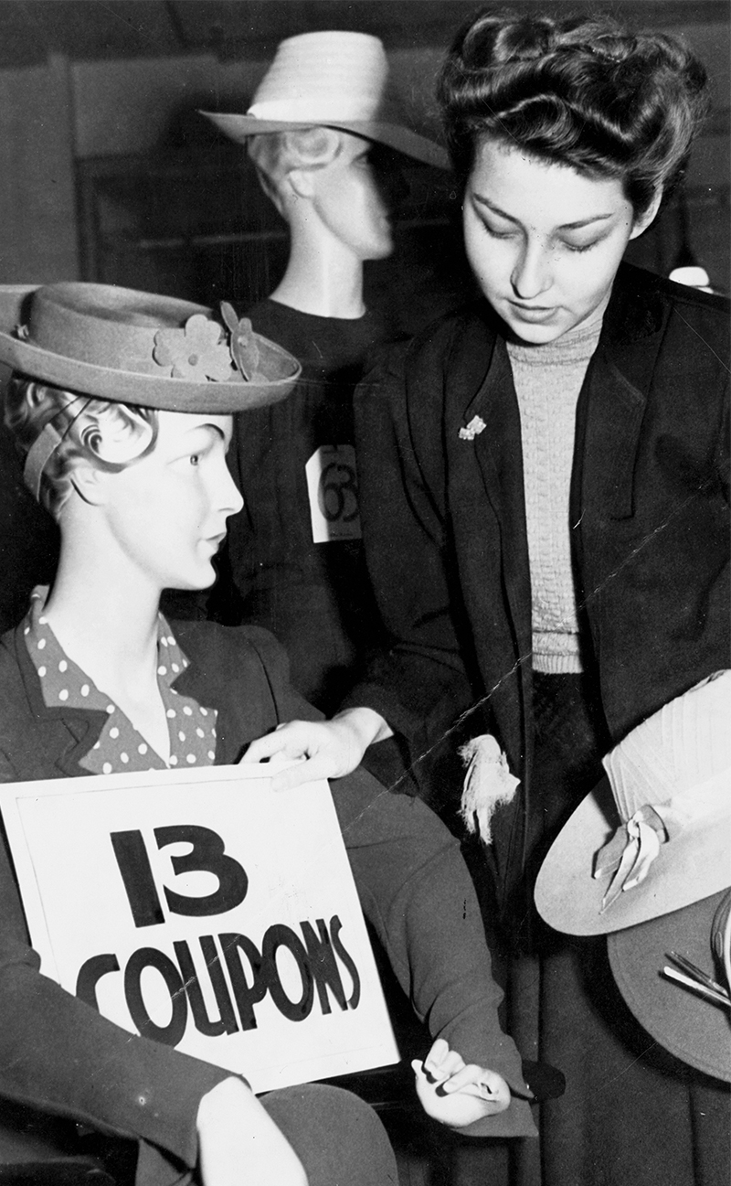 A mannequin wears a dress with its price in ration coupons