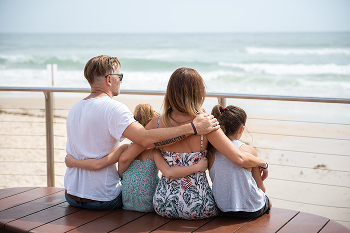 Family watching waves at beach