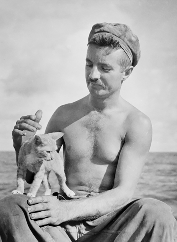 A seasick cat is tended by Sapper Mick Marton of Nowra