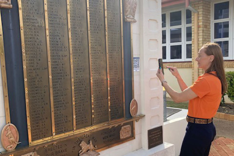 Woman using Gayndah Cenotaph QR code RSL Queensland