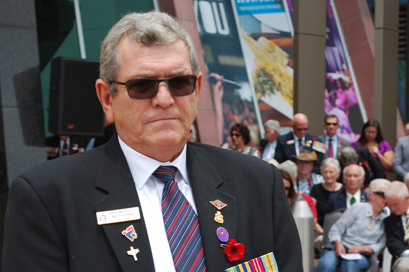 Ken laying a wreath