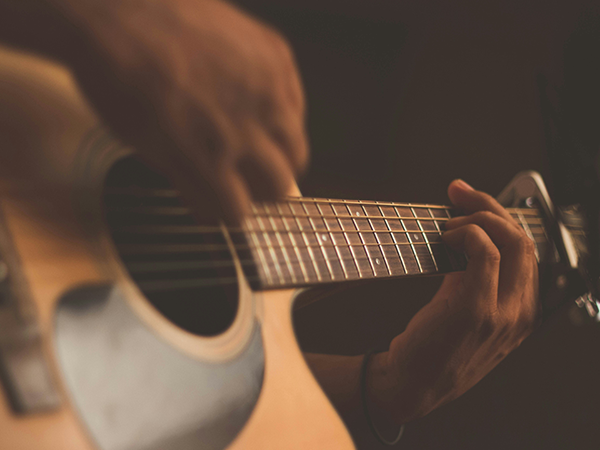 Person playing an acoustic guitar