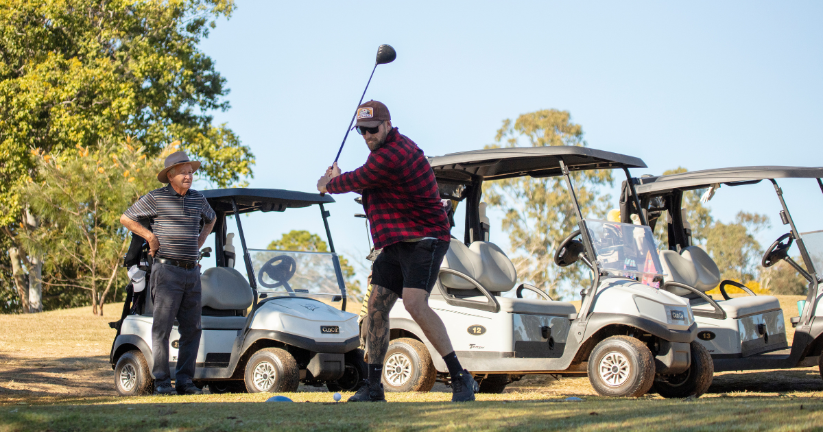 Man with a golf club lining up to tee off at Kilcoy Golf Club