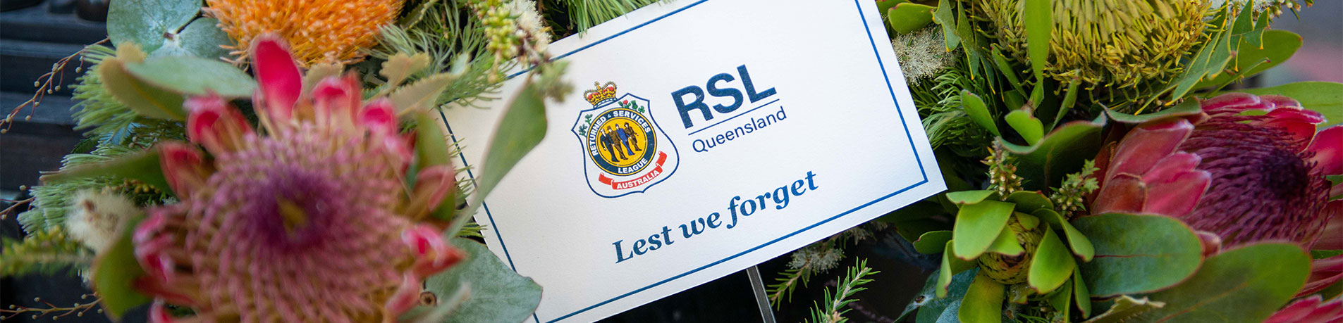 Lets we forget card sitting within a wreath