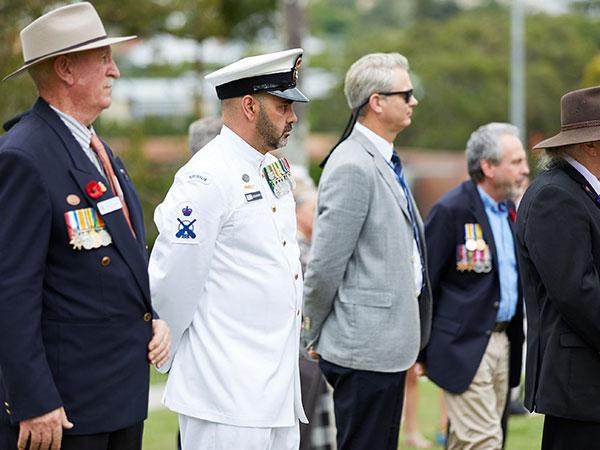 Current serving and veterans standing at an ANZAC Day service