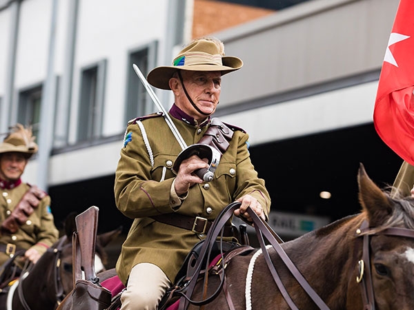 Army personnel on horse back riding in an ANZAC Day March
