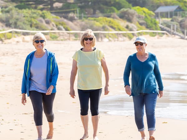 Three women walking on the beach
