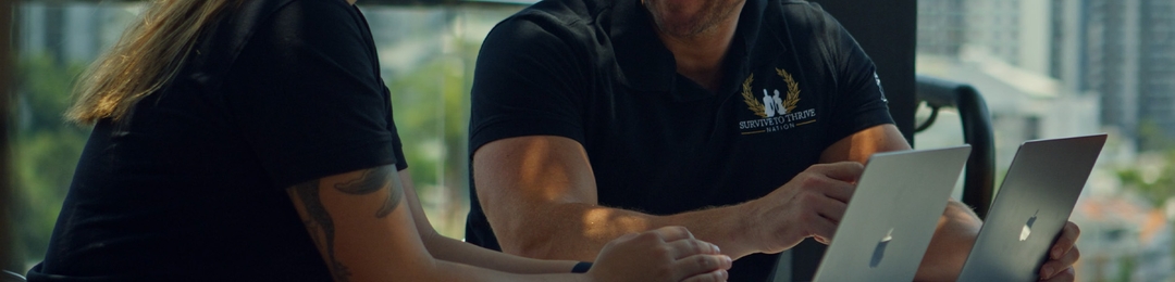 Survive To Thrive Nation staff in front of laptop