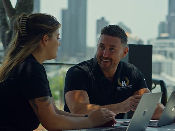 Survive To Thrive Nation staff in front of laptop