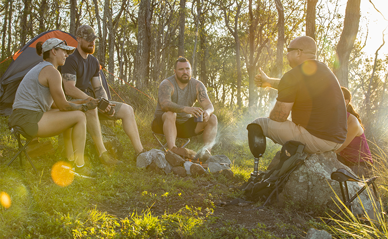Veterans talking around a campfire
