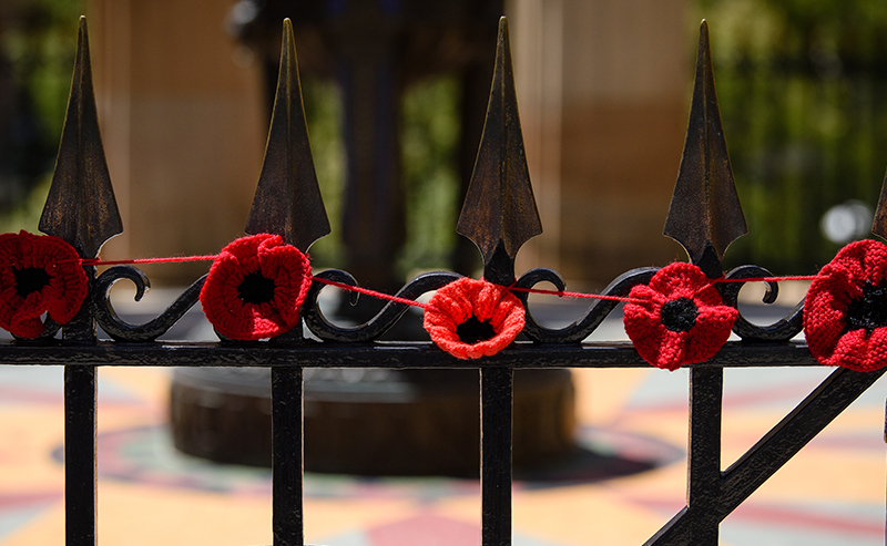 Handcrafted poppies on the fence of the Shrine of Remembrance