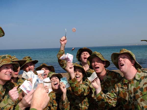 Image: Defence Australia |  Warrant Officer Class Two (WO2) Gary Ramage Members of the 2003 Gallipoli Contingent enjoy a traditional game of two-up on North Beach at Gallipoli during a break from rehearsing for ceremonial duties.